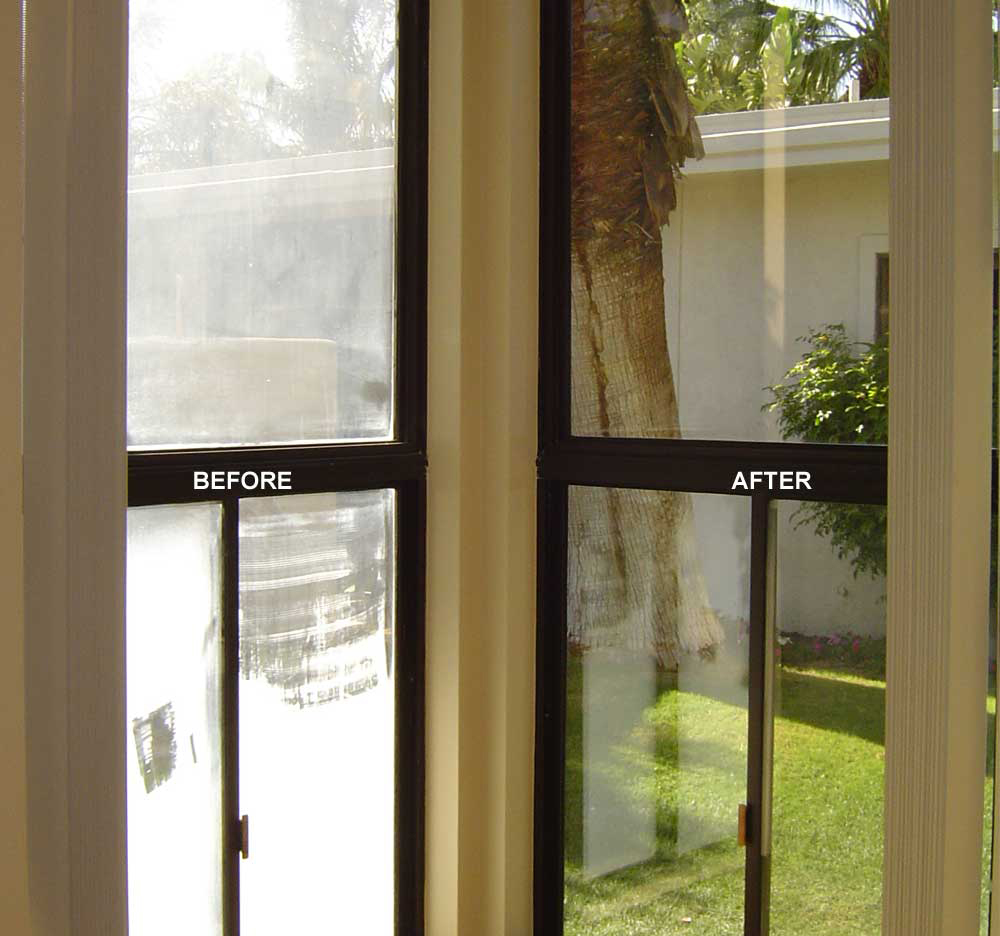 A before/after photos shows a window. The before side looks opaque with hard water stains. The after side shows clear windows outside is a green lawn and a large tree. 